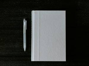 white printer paper on black wooden table