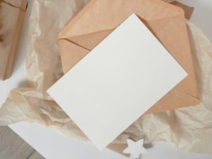 a white piece of paper sitting on top of a piece of brown paper
