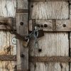 brown wooden door with padlock